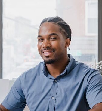 Smiling man sitting at desk in office