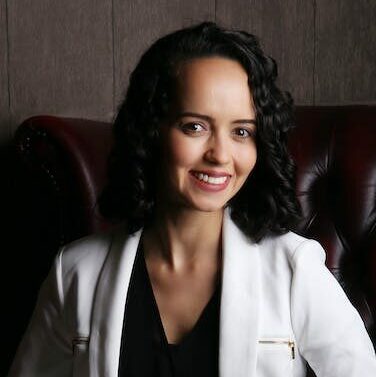 Stylish young businesswoman sitting in leather armchair